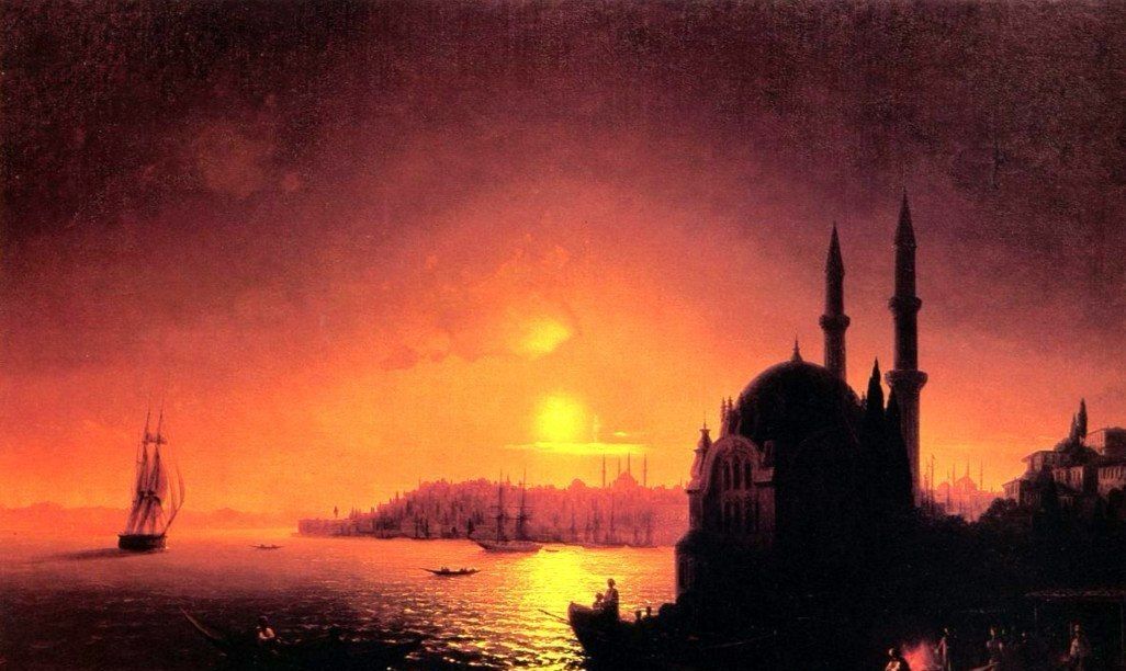 The harbour after dark, a red sky behind the minarets and a fire burning on the quay