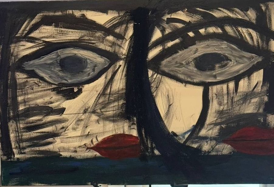 Bold black-and-cream painted face with two large eyes and a red mouth