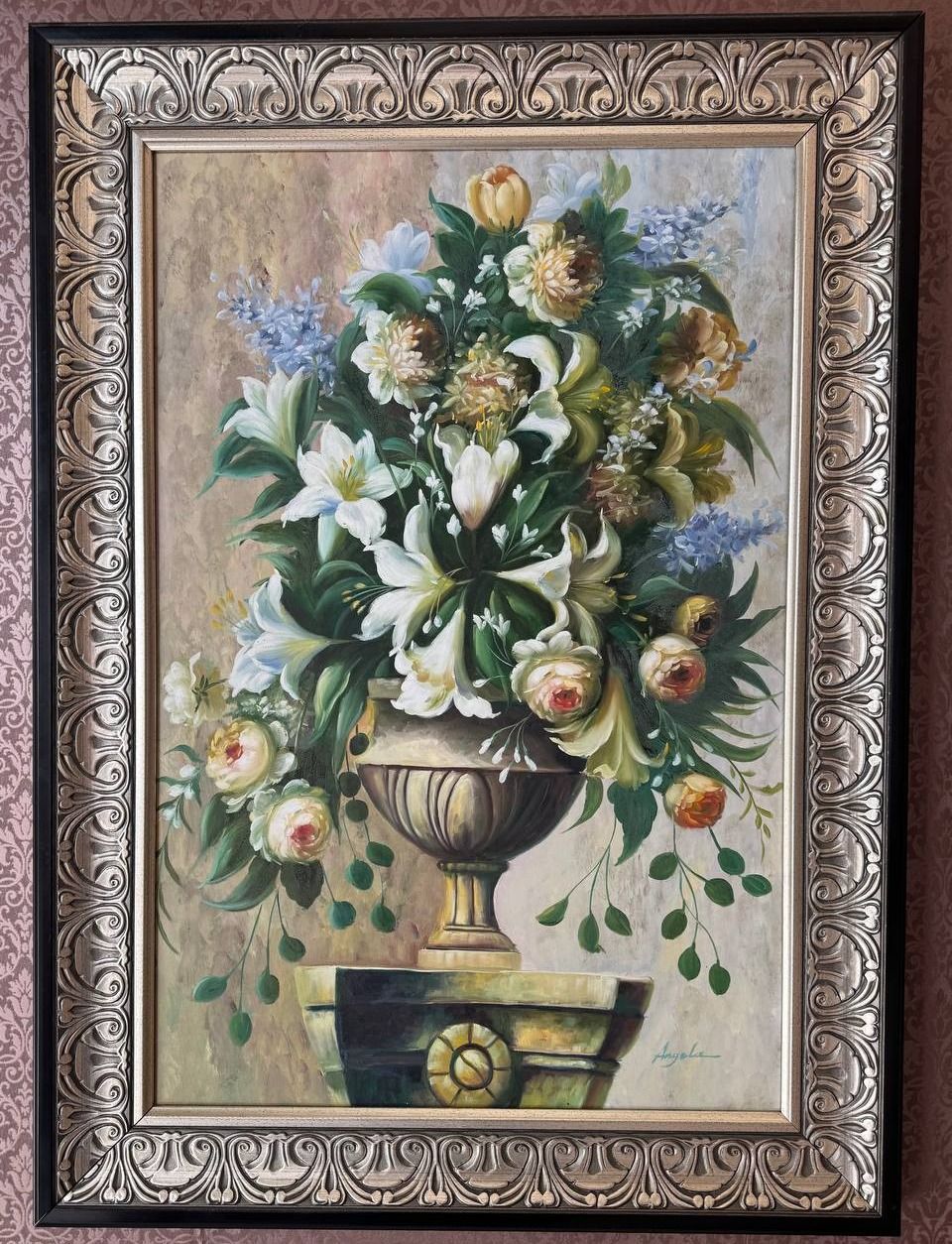 Still life of lilies, roses and hyacinths arranged in a fluted stone urn