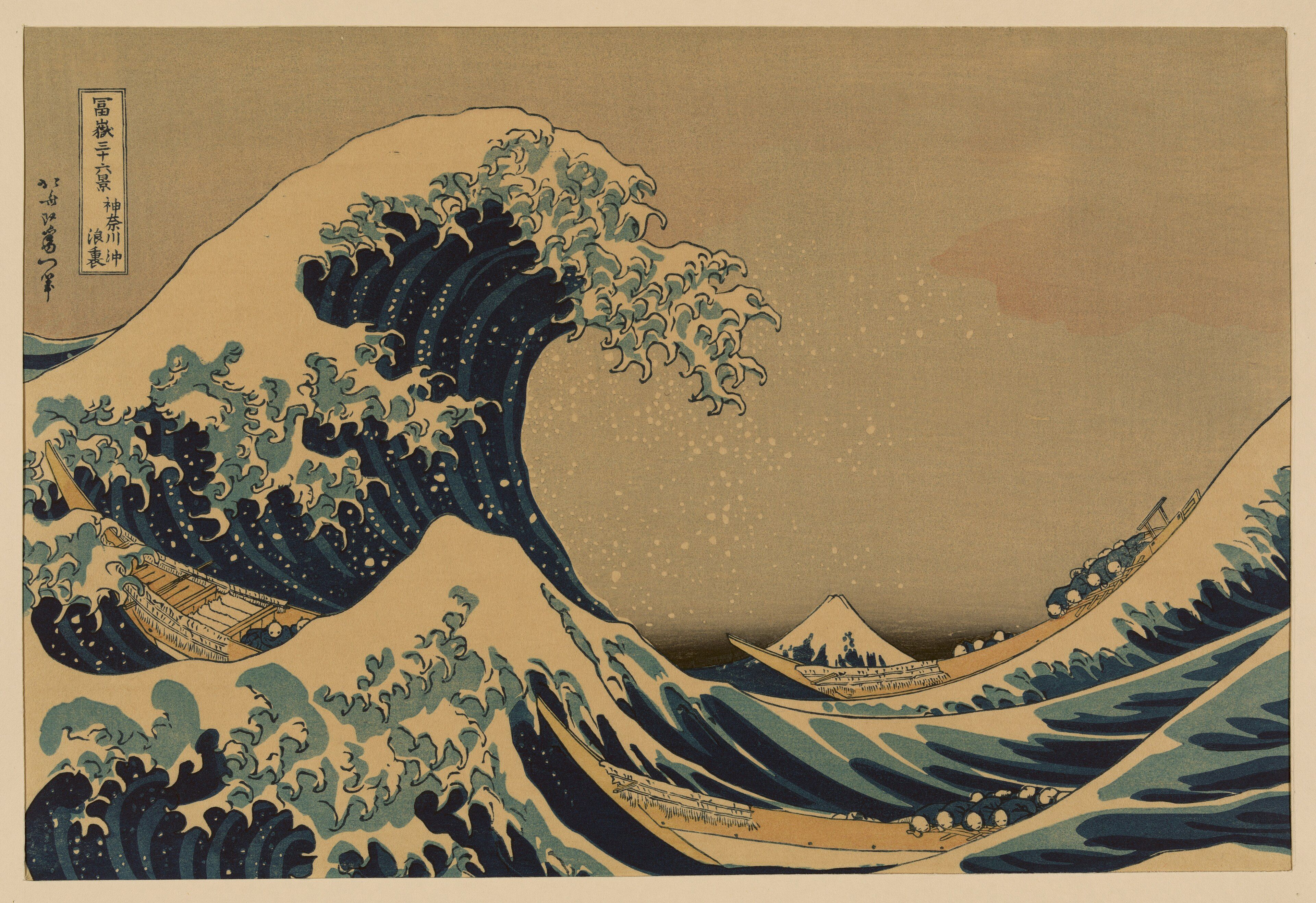 A woodblock print of a great clawed wave curling over three low boats, with a small snow-capped Mount Fuji beyond