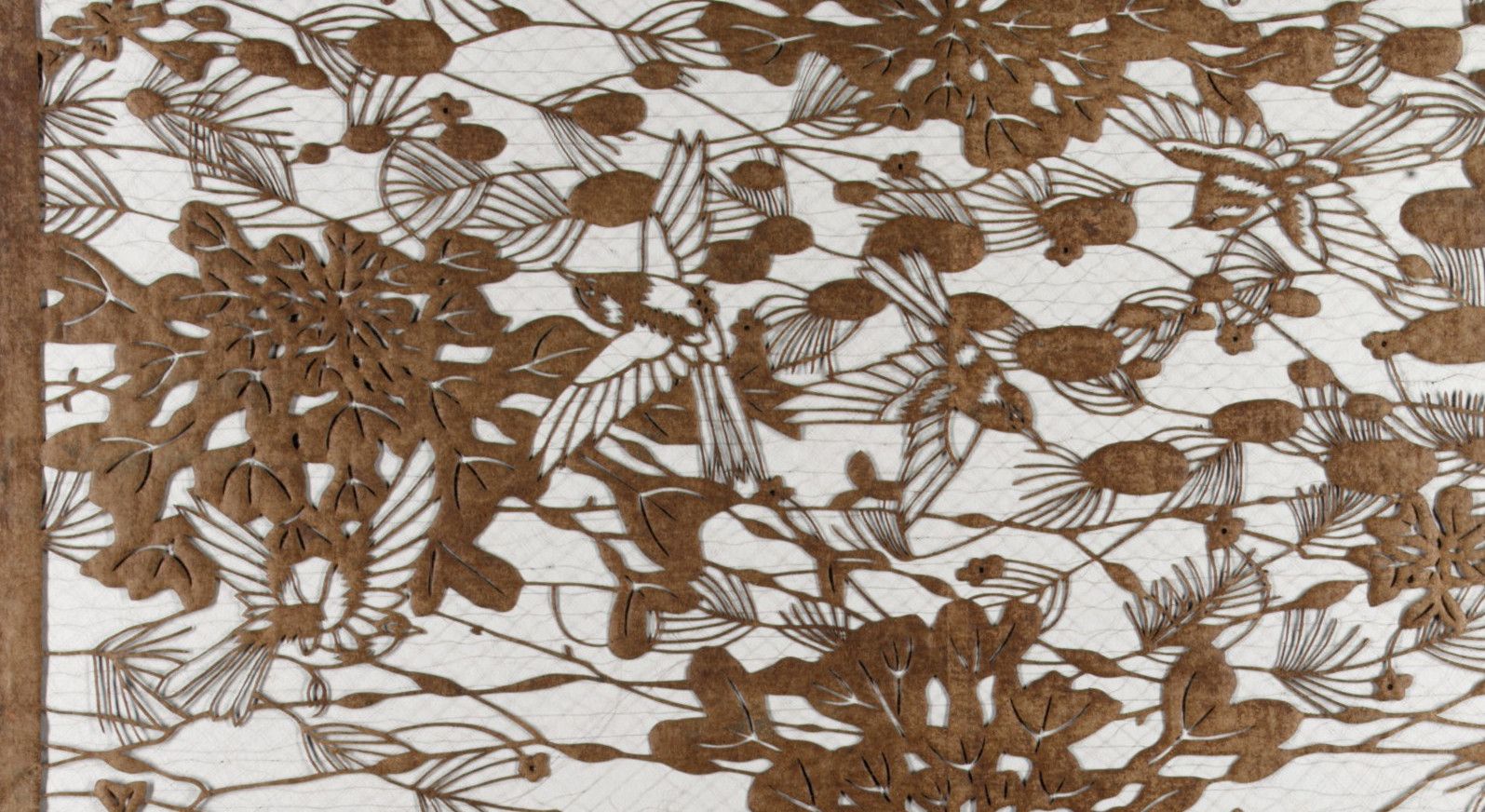 Pine needles in fanned clusters with flower heads and small buds between them, cut from brown paper over a pale ground