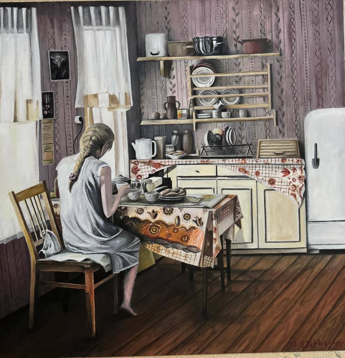 Oil painting of a girl seated at a laid table in a papered kitchen, a plate rack and white refrigerator behind her