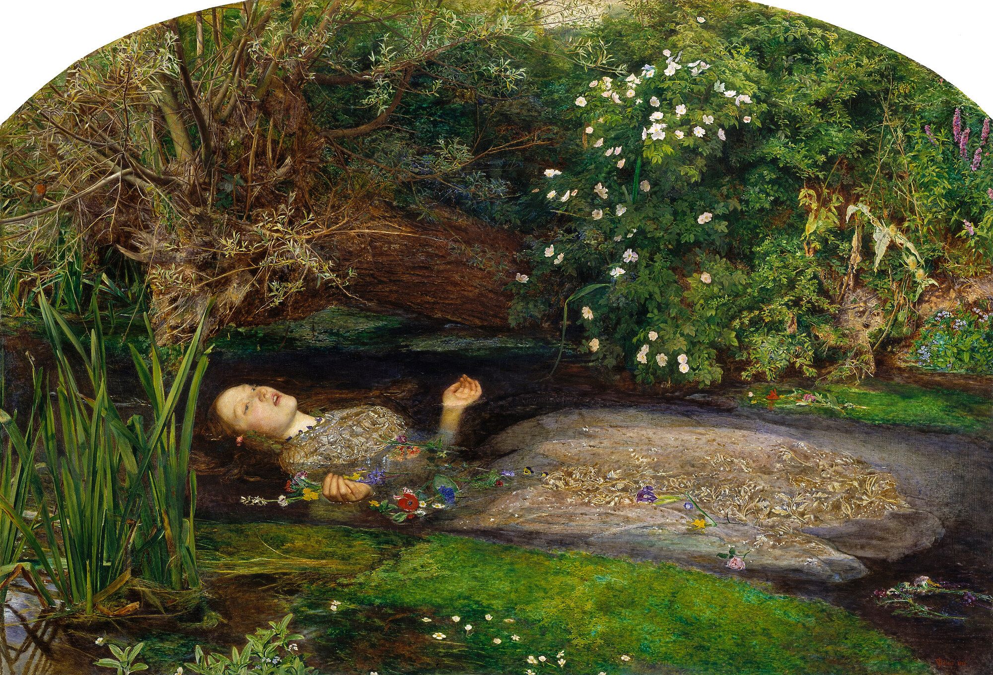 A woman in an embroidered dress floating on her back in a dark stream, her hands open, flowers scattered on the water