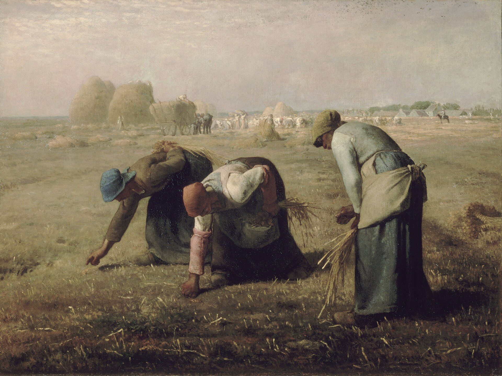 Three women bent low over a cut field gathering fallen ears of corn, the harvest and its stacks going on far behind them