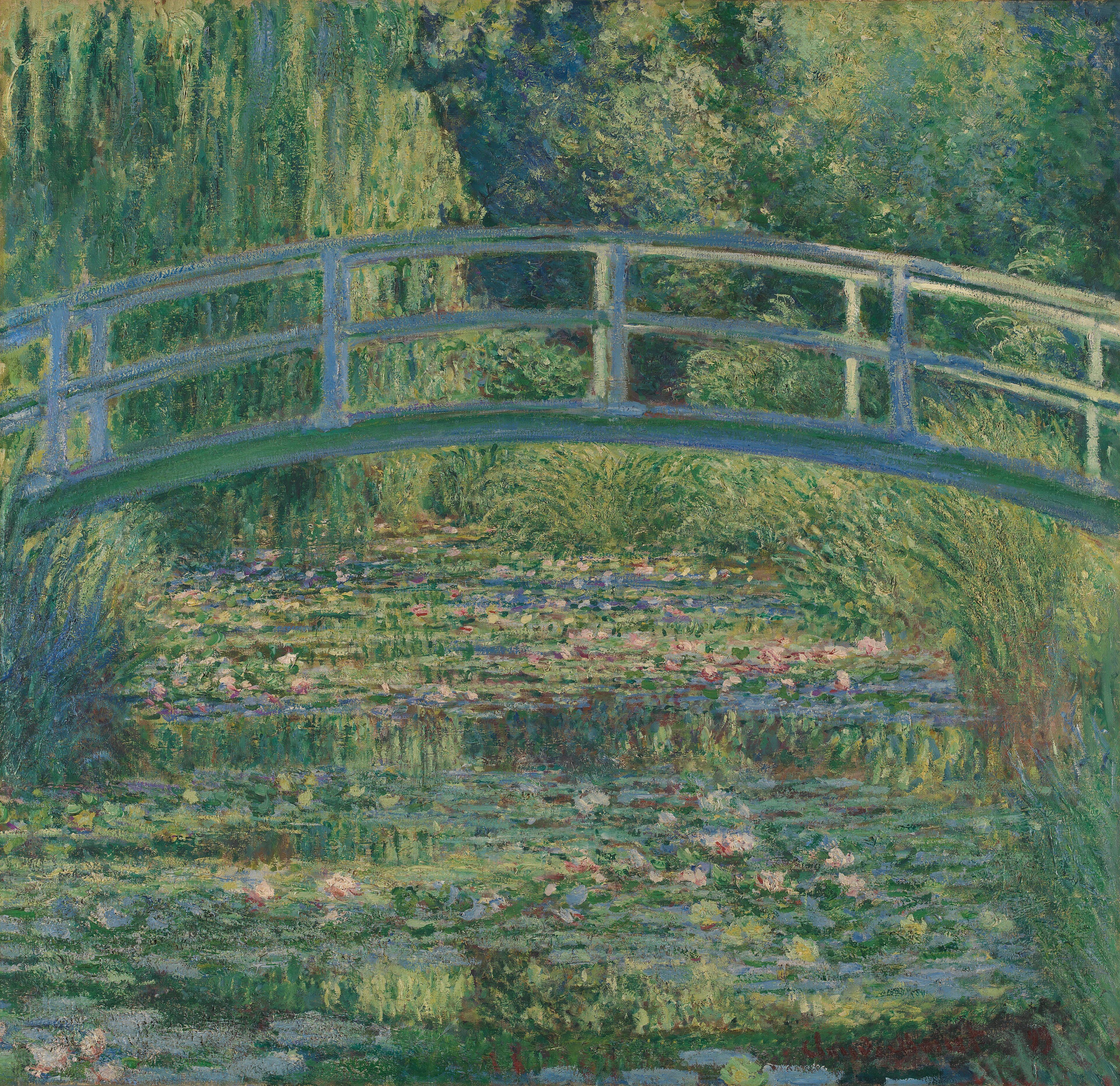 A green arched Japanese footbridge crosses a lily-choked pond enclosed by dense willow