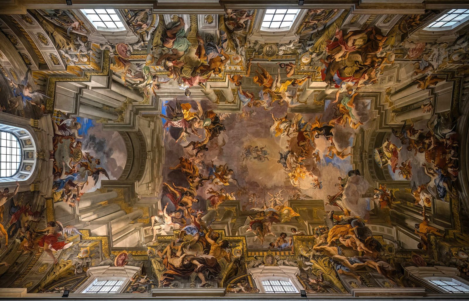 A flat ceiling painted as open architecture rising into sky, with columns and figures carrying the eye upward
