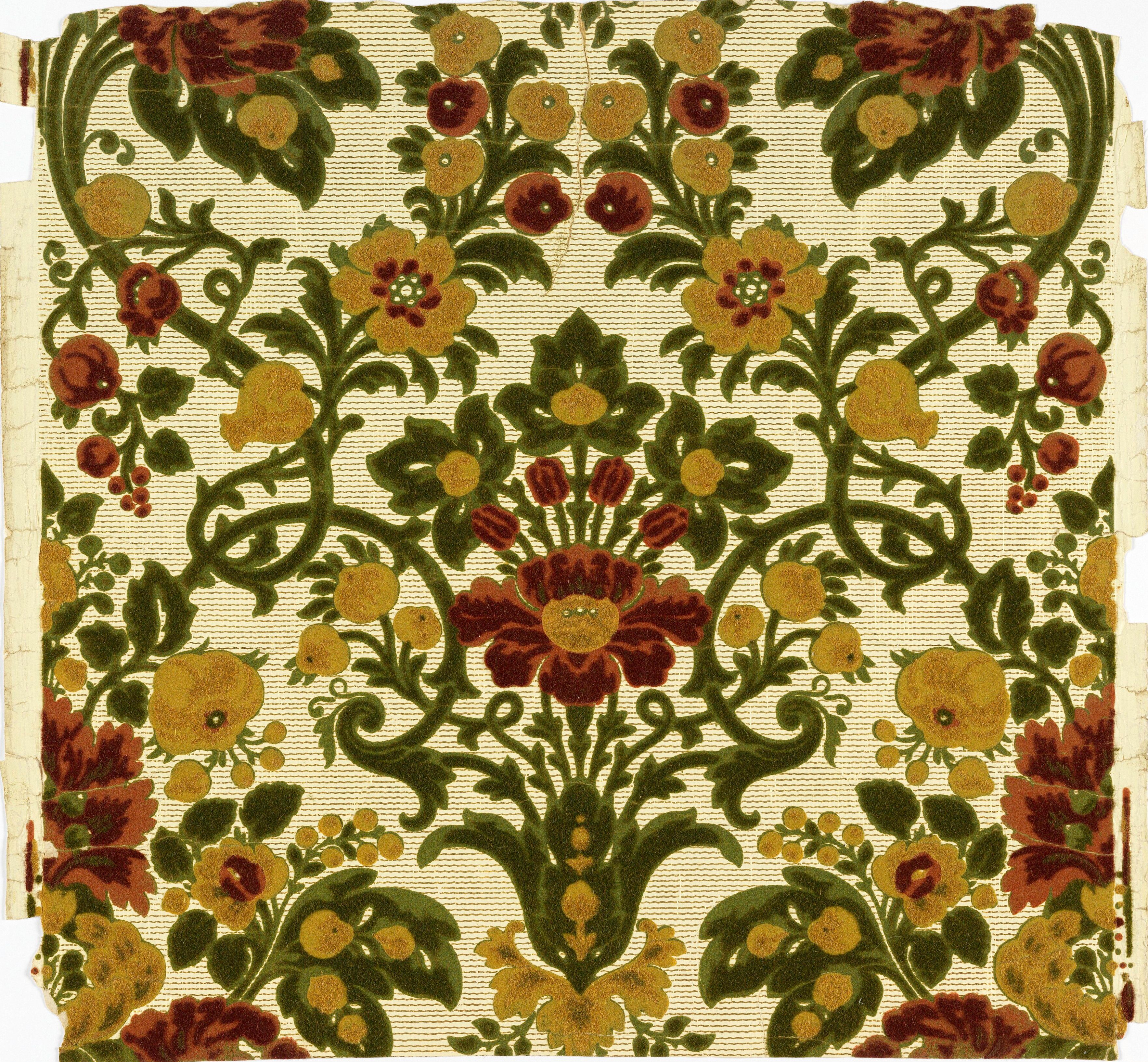 A symmetrical bouquet of dark green foliage with red and gold flowers, repeating in a drop across a cream ground