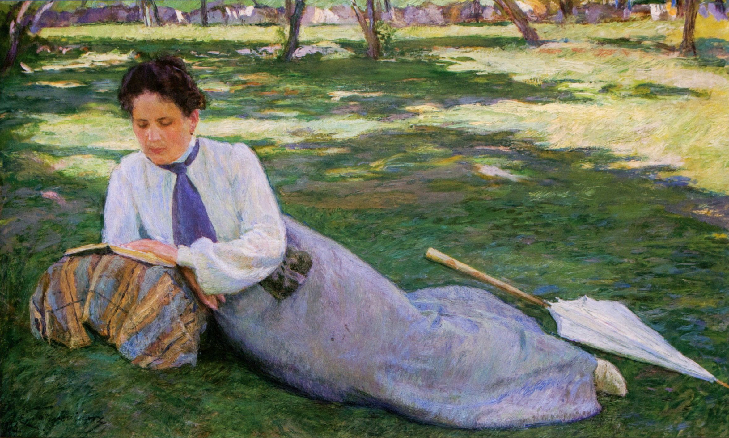 A woman in a white blouse and blue tie reclines on sunlit green grass reading a book, a folded white parasol beside her in an orchard