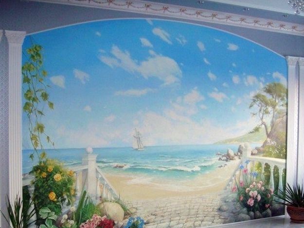 A wall painted as an arch between plaster columns opening onto a beach, a sailing ship on the water and flowers along a balustrade