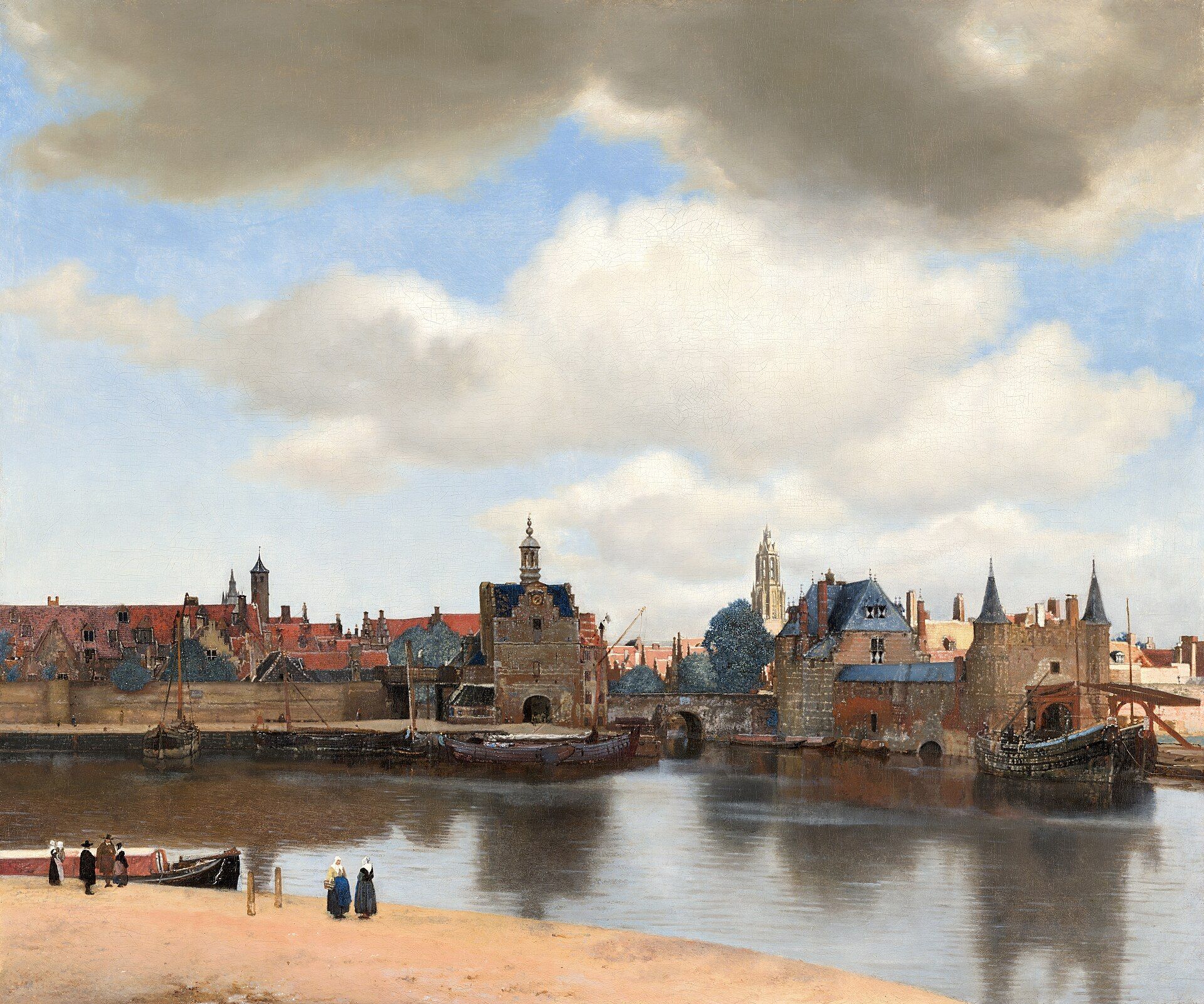 A town seen from across still water under a wide sky of heavy cloud, red roofs and a sunlit tower behind a dark gate, small figures on the near bank