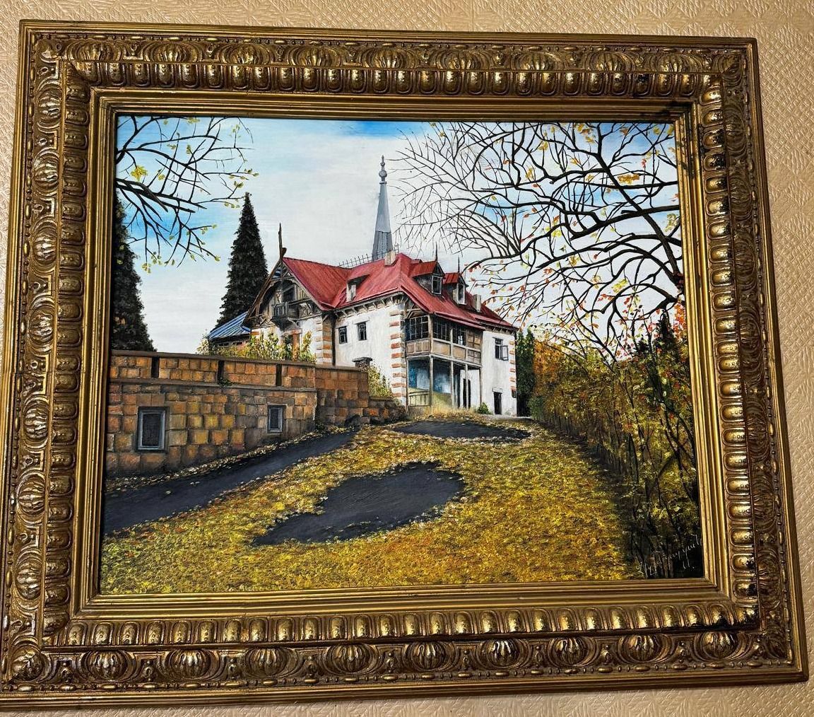 Autumn landscape with a red-roofed villa standing above a leaf-strewn drive